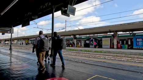 Tourists-Walking-Along-Platform-At-Bologna-Centrale-Train-Station