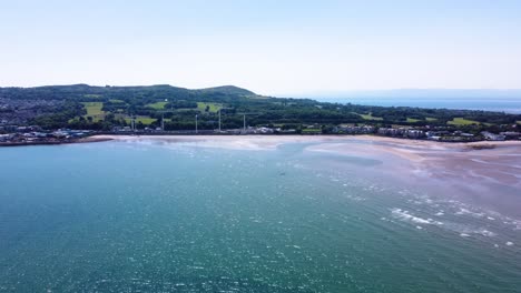 Aerial-Shot-of-a-Beautiful-Turquoise-Beach-in-Howth,-Ireland