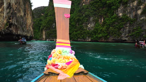Bow-or-Head-of-traditional-boat-over-beautiful-crystal-clear-water-in-Thailand,-POV-Maya-Bay
