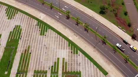 Drone-look-down-fly-by-of-dual-carriage-way-with-single-truck-onto-park