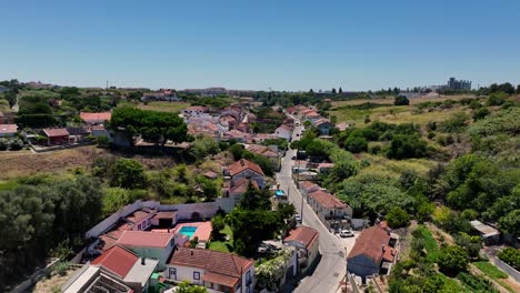 Drone-flying-up-the-hill-over-the-road-and-the-hills-at-Porto-Brandao,Portugal