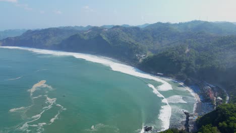 Ocean-waves-hitting-coastline-of-Indonesia,-aerial-drone-view