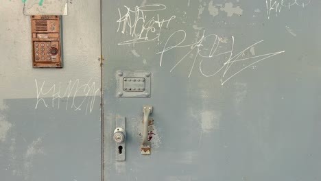 USSR-Soviet-era-residential-prefab-building-entrance-door-with-code-and-graffiti