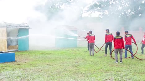 Firefighter-using-water-fire-extinguisher-to-fighting-with-the-fire-flame-from-triplex-shop-accident