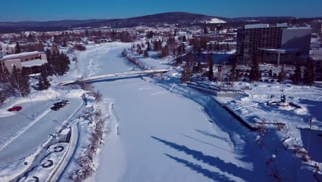 4K-Drone-Video-of-The-William-Ransom-Wood-Centennial-Bridge-over-Frozen-Chena-River-in-Downtown-Fairbanks-Alaska-on-Snowy-Winter-Day