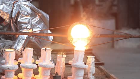 The-casting-prepared-in-high-celsius-heat-is-being-filled-inside-the-mold-and-working-with-safety-purpose-in-mind