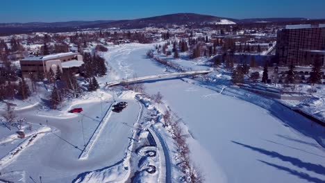 4K-Drone-Video-of-The-William-Ransom-Wood-Centennial-Bridge-over-Frozen-Chena-River-in-Downtown-Fairbanks-Alaska-on-Snowy-Winter-Day