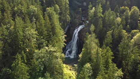 Gorgeous-aerial-view-of-waterfall-in-middle-of-forest,-Austria,-Gollinger