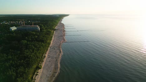 Experience-the-breathtaking-beauty-of-a-summer-sunset-on-a-picturesque-Baltic-Sea-beach,-captured-perfectly-by-a-drone