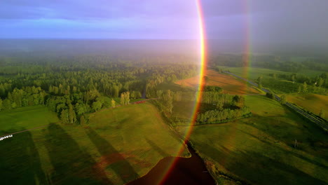Rainbow-Light-Shining-Over-Picturesque-Countryside-During-Sunrise
