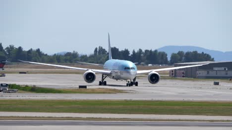 Frontal-View-of-a-Korean-Air-Triple-Seven-at-the-Airport,-Sunny-Day