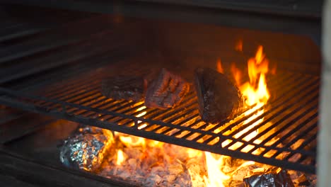 Charcoal-oven-at-latin-grill-restaurant-with-premium-angus-beef-steak-picanha-and-top-sirloin-over-grid-grill-fire-flames