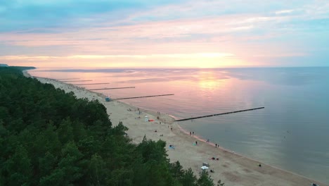 Experience-the-breathtaking-beauty-of-a-summer-sunset-on-a-picturesque-Baltic-Sea-beach,-captured-perfectly-by-a-drone