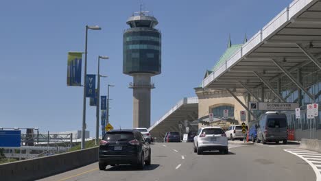 Cars-Arriving-at-the-Drop-Off-Zone-of-Vancouver-Airport-with-ATC-Tower
