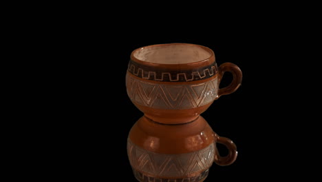 Small-ceramic-clay-cup-handmade-in-Chile-spins-with-traditional-design