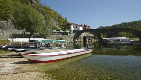 Boats-in-the-harbour-in-Rijeka-Crnojevica,-Montenegro-near-the-coast-of-Skadar-lake