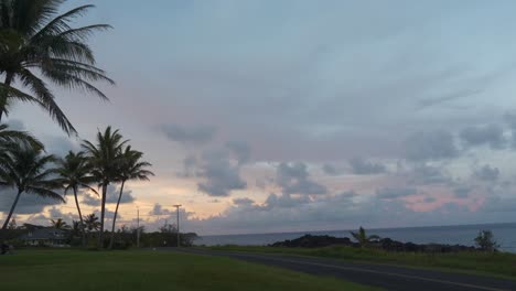 Sunset-over-Hawaii-Island-cliffs-and-Pacific-ocean-with-a-house-and-road-in-the-foreground