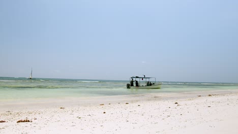 Boat-At-The-White-Sandy-Shore-Of-Diani-Beach-in-Kenya,-Africa