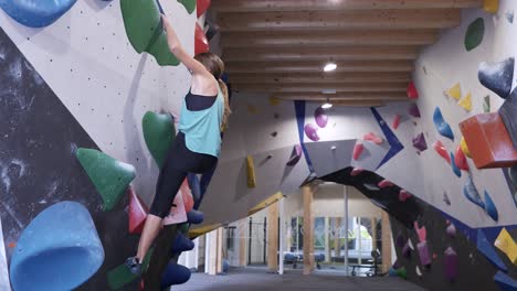 Sportswoman-exercising-on-climbing-walls