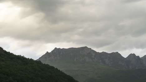 Gray-clouds-floating-over-rocky-mountain-ridge