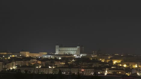 Illuminated-historic-city-on-hill-in-evening