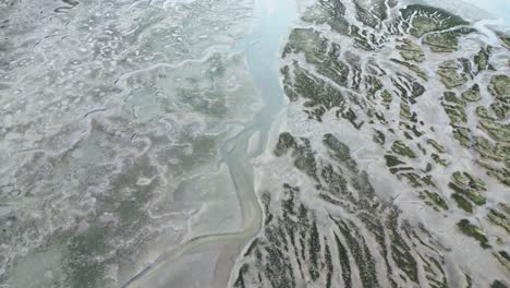 Drone-view-of-rivers-flowing-through-wild-terrain