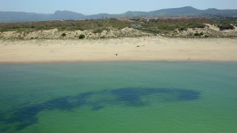 Sandy-beach-with-wavy-green-water