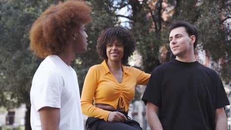 Happy-multiethnic-friends-having-conversation-on-street