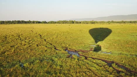 Low-flying-hot-air-balloon-ride-flight-over-empty-African-grassland-savanna-in-Maasai-Mara-National-Reserve,-Kenya,-Africa-Safari-adventure-tours-in-Masai-Mara-North-Conservancy