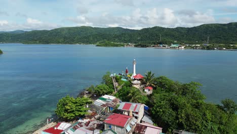 Aerial-parallax-around-light-house-lookout-and-fishing-village-homes-in-catanduanes
