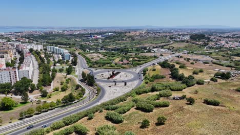 Drone-shot-flying-over-a-roundabout-and-som-roads-with-a-view-over-the-landscape-