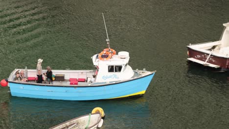 Zoomed-in-shot-showing-tourists-heading-out-on-a-fishing-trip-leaving-from-Polperro