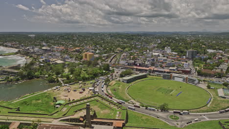 Galle-Sri-Lanka-Aerial-v2-drone-flyover-fort-and-cricket-stadium-capturing-railway-station-and-cityscape-of-Kaluwella-and-Walawwatta,-panning-towards-bay-harbor---Shot-with-Mavic-3-Cine---April-2023