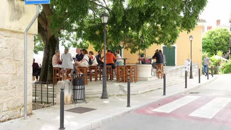 People-chatting-and-drinking-at-bar-area-in-Vrsar,-Istria-County,-Croatia