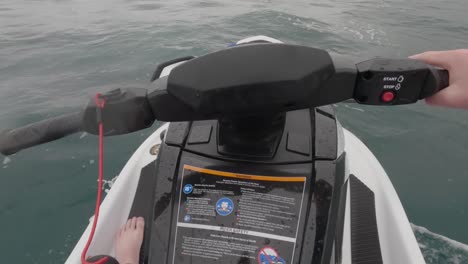 POV-shot-of-a-jet-ski-rider-driving-slowly-across-the-ocean-showing-the-kill-switch