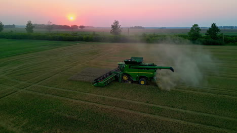 Farmer-working-until-sunset-to-harvest-crops---aerial