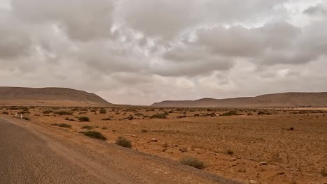 Driving-along-straight-road-through-the-desert-landscape-of-Tunisia