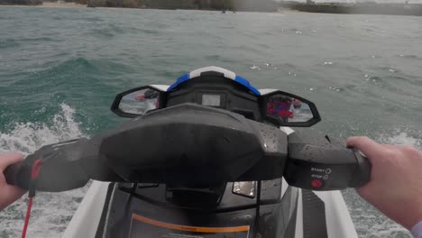 POV-shot-of-a-Jet-skier-catching-up-and-stopping-with-the-other-jet-skiers-off-the-coast-of-Newquay