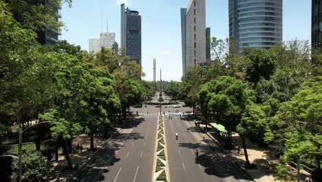 frontal-drone-shot-of-cyclists-exercising-on-reforma-avenue-in-mexico-city-during-Sunday