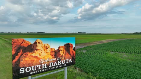 Welcome-to-South-Dakota-establishing-shot-of-road-sign-in-rural-area-during-summer