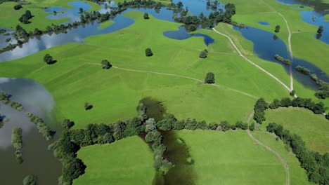 Picturesque-lush-green-swampland,-intermittent-lake-Slovenia,-aerial-establisher