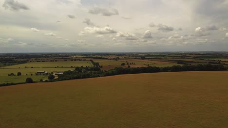 Drone-shot-over-a-country-road-looking-out-on-to-countryside-fields