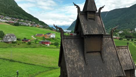 Aerial-pedestal-down-length-of-historic-Hopperstad-Stave-Church,-Vik,-Norway