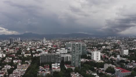 Powerful-storm-flowing-above-cityscape-of-Mexico,-aerial-drone-view