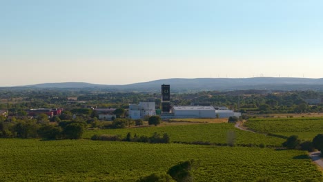 Aerial-drone-trip-to-the-Carte-Noire-coffee-factory-in-Montpellier,-surrounded-by-vineyards