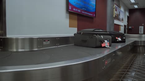 Luggage-handled-as-they-move-through-baggage-claim