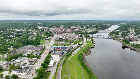 Aerial-view-of-Bangor,-Maine-with-the-Penobscot-River-flowing-alongside-the-city