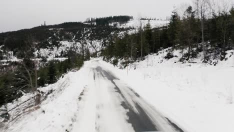 Rear-Perspective-Of-Audi-Car-Driving-Through-A-Snowy-Road-In-Slovakia
