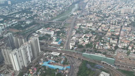 Greater-Chennai-City-is-seen-in-aerial-video-footage-along-with-buildings,-Metro-Rail-stations,-and-Koyembedu-Bridge