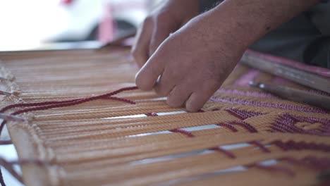 close-up-scene-of-a-man-embroidering-with-his-skillful-skills